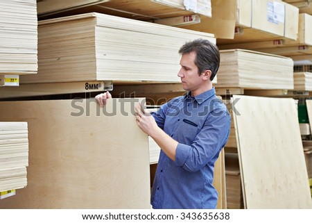 Man chooses plywood for the construction of the store