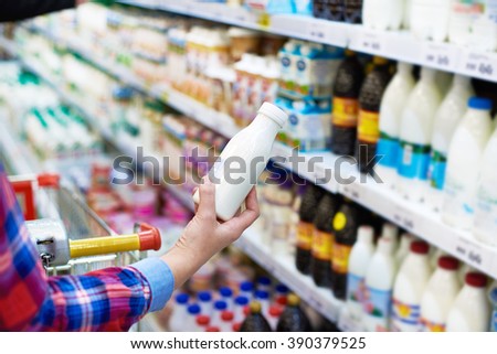 Woman shopping dairy product in grocery store
