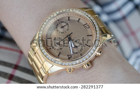 Gold Watches with diamonds on female hand