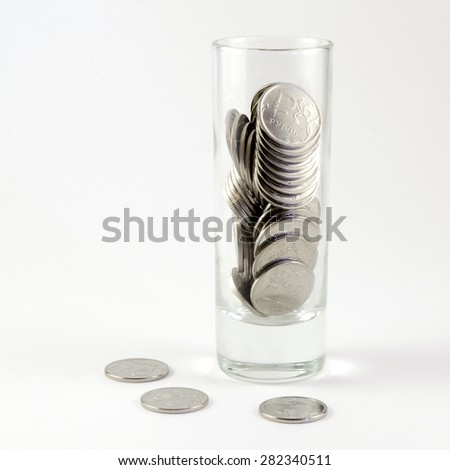 Metal coins in one Russian rouble in a shot glass