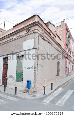 Disrepair Old Vintage Ruined Dirty Home For Sale (Se Vende) with pedestrian crosswalk in Urban Residential Neighborhood in Spain Europe