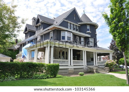 Suburban Three story tall Victorian Home under Repair Remodeling