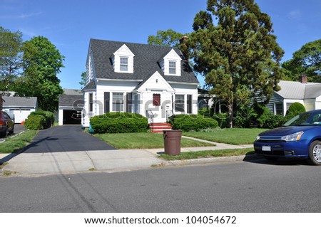 Trash Can Curbside Suburban Two Story Cape Cod House Residential Neighborhood - stock photo