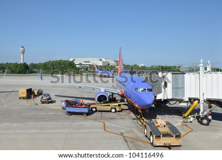 ORLANDO, FLORIDA - MAY 27: USA\'s number one low budget airline Southwest, founded in 1967 has largest number of 737 Boeing planes worldwide, is loading luggage for takeoff from Orlando. May 27, 2012.