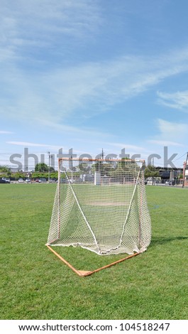 Empty Lacrosse Field Practice Net sunny blue sky day
