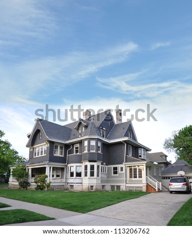 Suburban Victorian style architecture home blue sky clouds day