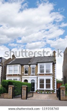 Suburban Home in London United Kingdom Europe residential neighborhood blue sky day with clouds