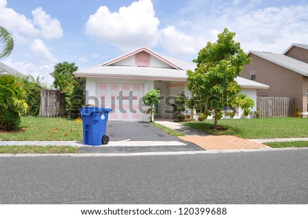 Recycle Trash Container Curb of Suburban Ranch Bungalow Home Sunny Blue Sky Day Clouds