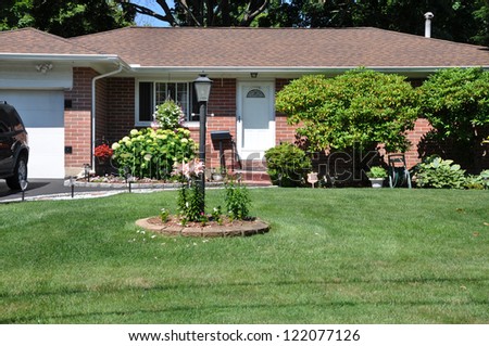Suburban Brick Ranch Style Home Landscaped Front Yard Lamppost Flowers