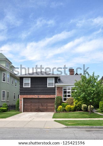 Suburban Home Landscaped front yard lawn Residential Neighborhood Blue Sky Clouds