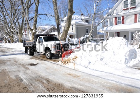 Huntington, New York - Feb 10: Plow Truck Clearing Snow On Suburban Street After Feb 8 Winter Blizzard Hit North East Region Of Usa Dumping At Least 2 Feet Of Snow In Huntington, Feb 10, 2013.