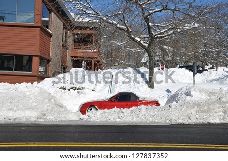 HUNTINGTON, NEW YORK - FEB 10: Parked Car damaged by plowers during night of Feb 8 blizzard that hit north east region of USA dumping 1 -2 feet of snow in parts of Huntington, New York Feb 10, 2013.