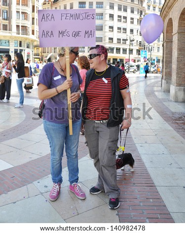 VALENCIA, SPAIN - MAY 25: Women talking holding sign written in Valencian (Now Feminists, Now More than Ever) during  women\'s rights protest organized by Casa de La Dona Valencia. May 25, 2013.