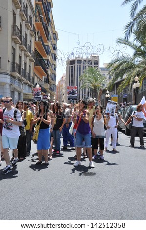 ALICANTE, SPAIN - JUN 15: Organized demonstration with people holding signs 