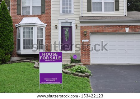 Real Estate House For Sale Sign on front yard lawn of Suburban Home Residential Neighborhood USA