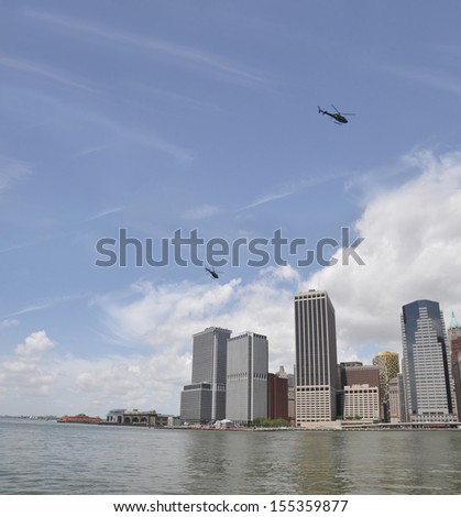MANHATTAN, NY - JUL 14: Two helicopters flying over lower Manhattan the southern most part of the island and the center of business and government of the City of New York, New York, USA, Jul 14, 2013.
