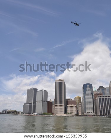 MANHATTAN, NY - JUL 14: Helicopter flying over lower Manhattan the southern most part of the island and the center of business and government of the City of New York. New York, USA, Jul 14, 2013.