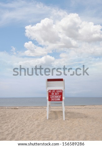Government Shutdown No Life Guard on Duty Sign on Lifeguard station seat Beach Blue Sky Clouds