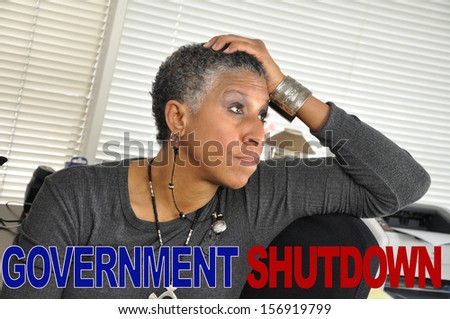 Government Shutdown Text Concern Mature Woman in Office Looking Upset
