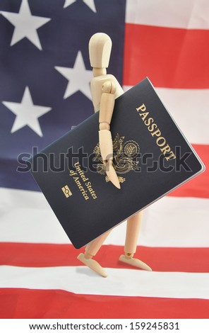 New American Passport under Arm of Male Wood Mannequin walking across American Flag