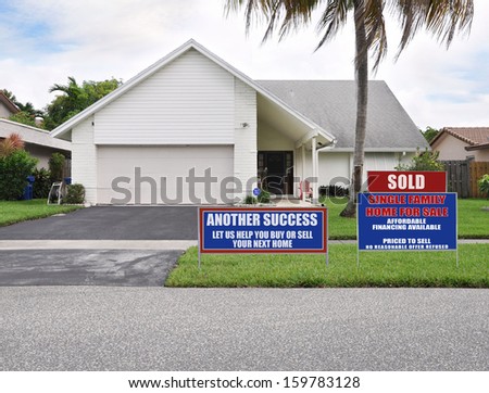 Sold Real Estate Sign Another Success Let Us Help you Sell Buy your next home Sign Front yard of Suburban Back Split Style Home Residential Neighborhood USA
