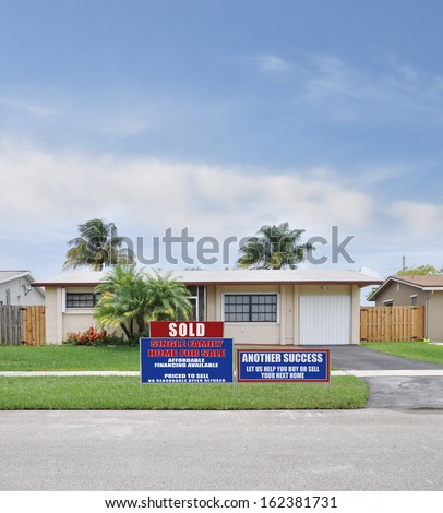 Sold For Sale Real Estate Sign Another Success Let Us Help you buy or sell your next home, Suburban Ranch style house Residential Neighborhood Blue Sky Clouds USA