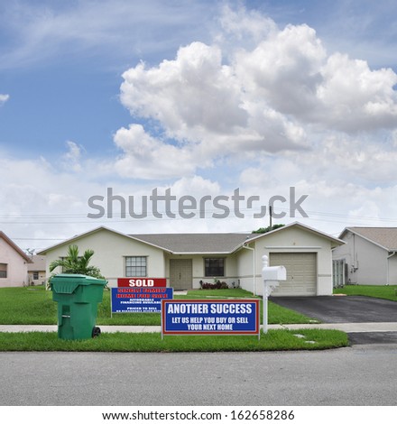 Sold Another Success Real Estate Sign Recycle Trash Container Suburban Ranch Style Home Mailbox Blue Sky Clouds Residential Neighborhood USA