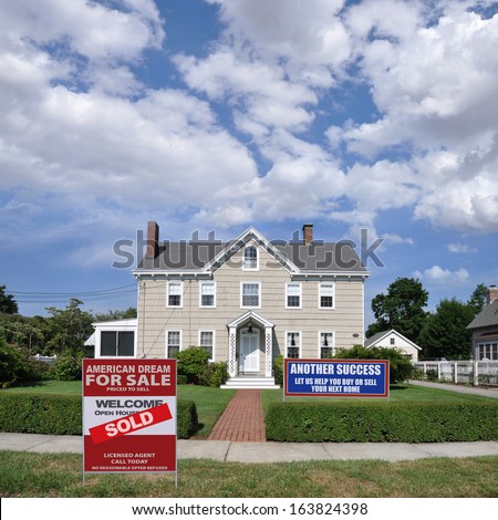Sold Real Estate Sign Another Success Let Us Help you Buy Sell Your Next Home Large Suburban Landscaped Home Residential Neighborhood USA Blue Sky Clouds