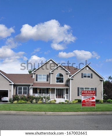 Sold Suburban McMansion Home Landscaped with Flowers Residential Neighborhood USA Blue Sky Clouds. Real Estate Sign (Another success let us help you buy / sell your next home)