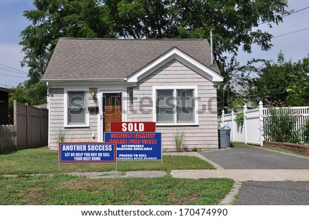 Real Estate Sign Sold (Another Success Let Us Help You Buy Sell your next home) Suburban Bungalow home residential neighborhood USA