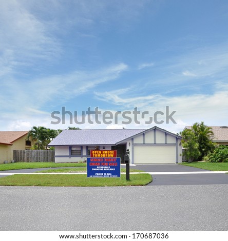 Open House For Sale Real Estate Sign Curbside Suburban Ranch style home residential neighborhood USA Blue Sky Clouds