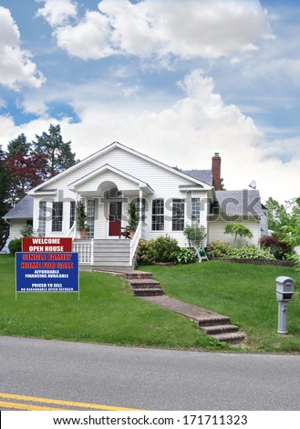 Real Estate open house for sale sign front yard landscaped lawn suburban home residential neighborhood USA blue sky clouds