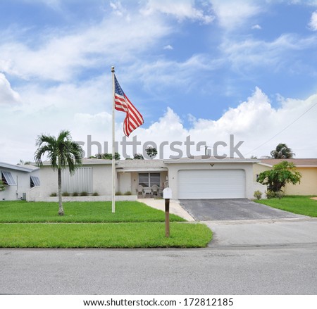 Sold Real Estate Sign \'Another Success let us help you buy sell your next home\' Suburban Ranch Style Two Car Garage Landscaped Home residential neighborhood blue sky clouds USA
