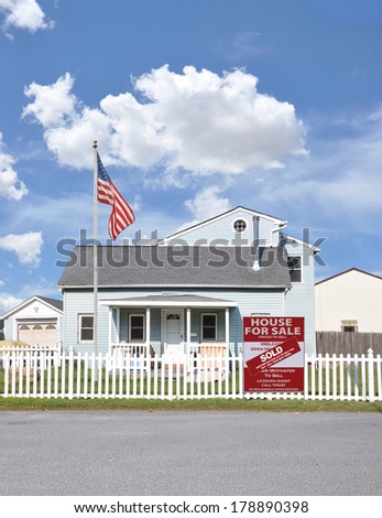 American Flag Pole Sold real estate sign (another success let us help you buy sell your next home) white picket fence Suburban Home Residential neighborhood USA Blue Sky Clouds