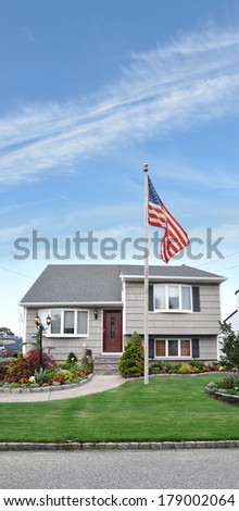 American Flag Pole Suburban Landscaped Lawn Residential Neighborhood Blue Sky Clouds USA