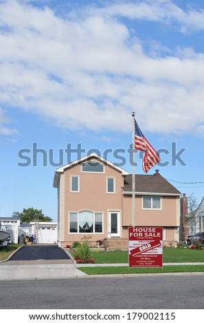 American Flag pole Real Estate Sold (another success let us help you buy sell your next home) Suburban Tan Home Landscaped Lawn Residential Neighborhood Blue Sky Clouds USA