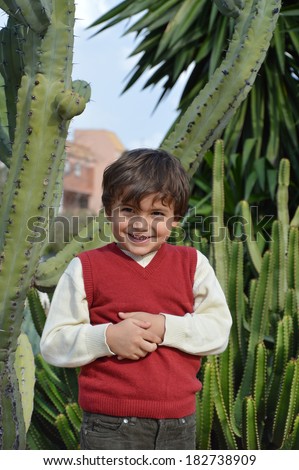 Boy Standing Nervous Smile Holding Handing Near Cactus Plants