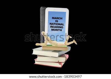 March is National Reading Month on Screen of Digital Tablet on Stack of Books with Wood Mannequin laying down isolated on black