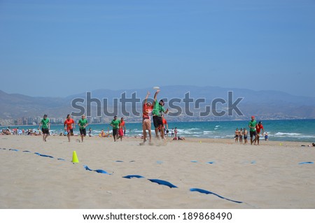 ALICANTE, SPAIN - APR 27: Frisbillanas a team from Seville wearing green is competing in the First Ultimate Frisbee Tournament held at San Juan Beach in Alicante, April 24, 2014.