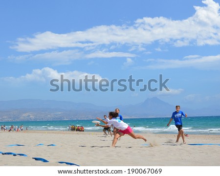 ALICANTE, SPAIN - APR 27: Alicante\'s frisbee team Barbaras wearing blue tee shirt is competing in the first Ultimate Frisbee Tournament Apr 26-27 held on San Juan Beach in Alicante. April 27, 2014.