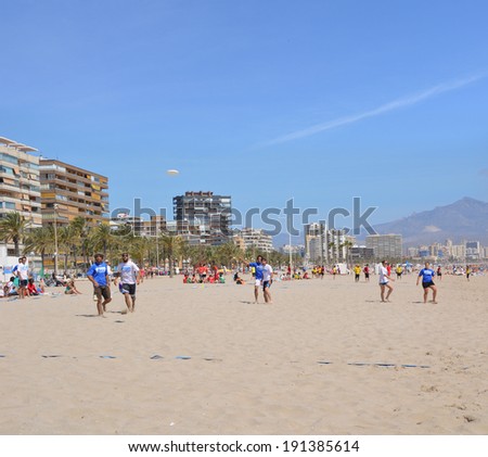 ALICANTE, SPAIN - APR 27: Frisbee passed by Alicante\'s Barbaras frisbee team  competing in the first Ultimate Frisbee Tournament hosted in Spain on the beach of San Juan in Alicante Apr 27, 2014.