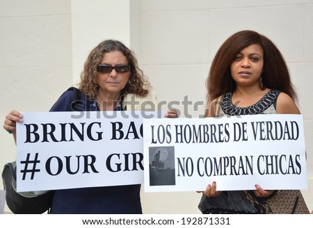 ALICANTE, SPAIN - MAY 14: Two women at protest march holding signs for release of girls taken by Terrorists Boko Haram in Chibok Gov. School. Organized by Assn of Nigerians in Alicante May 14, 2014.