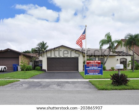Real estate For Sale Open House Welcome Sign Suburban Ranch Home Two Car Garage Landscaped front yard residential neighborhood USA blue sky clouds