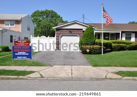 American Flag pole Real Estate For Sale Open House Welcome sign driveway entrance suburban home residential neighborhood USA clear blue sky