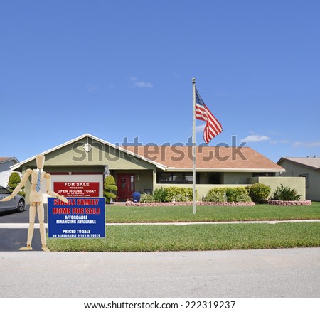 American flag pole Mannequin standing next to Real Estate for sale open house welcome sign front yard lawn of suburban ranch style home residential neighborhood blue sky USA