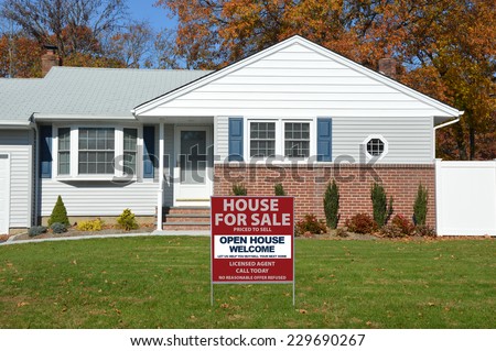 Real Estate For Sale Open House Welcome sign on front yard lawn of suburban home fall day residential neighborhood USA Blue Sky