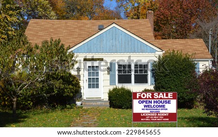 Real Estate For Sale Open House Welcome sign on front yard lawn of suburban home residential neighborhood USA fall season