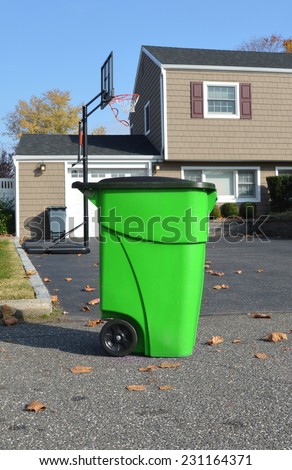 Green Recycle Trash Container suburban neighborhood street suburban home blue sky USA