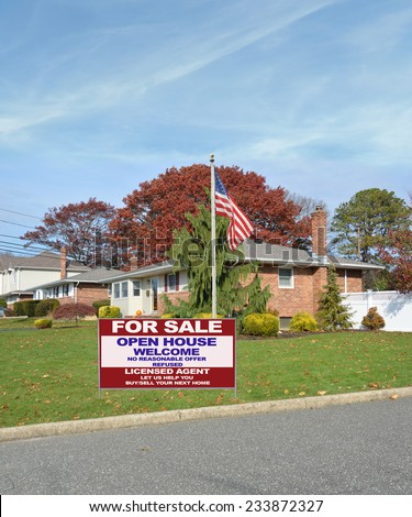 American flag pole Real Estate for sale open house welcome sign suburban ranch style home autumn season day residential neighborhood blue sky clouds USA
