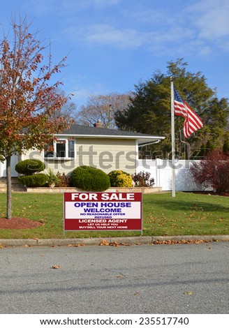 American flag pole For sale sign open house welcome sign Suburban home autumn day tree residential neighborhood blue sky clouds USA